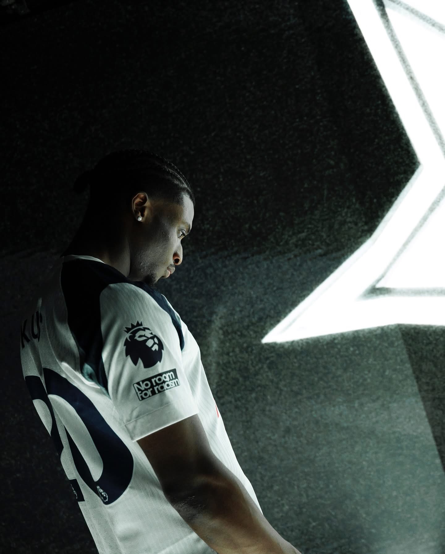 Mohammed Kudus in Tottenham Hotspur jersey, facing a star-lit background during official club unveiling.